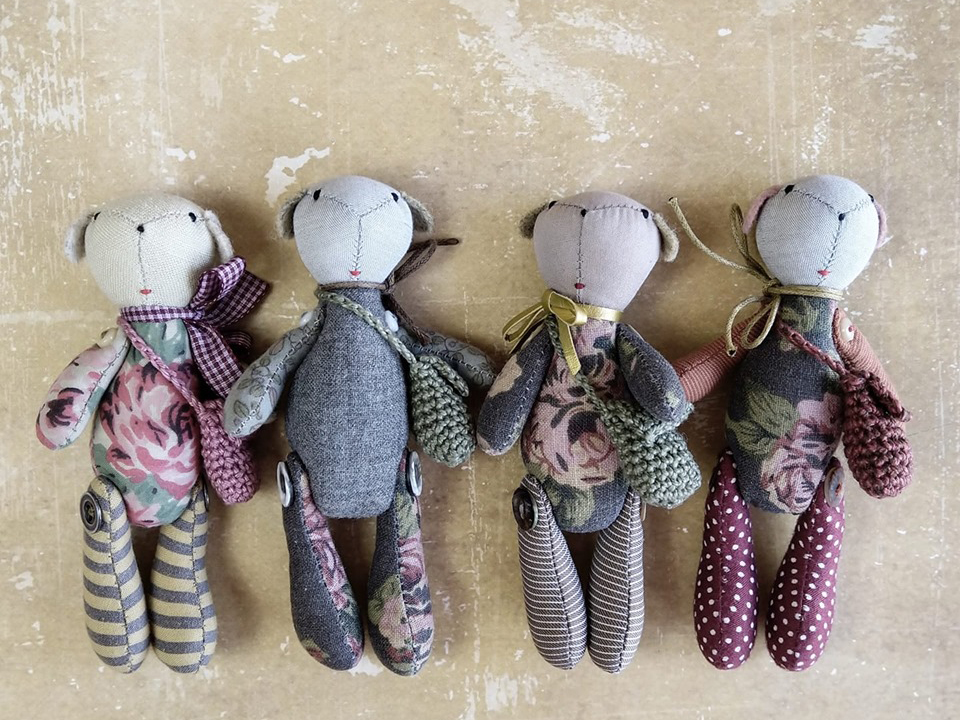 Zdjęcie promocyjne pracowni.  Na zdjęciu cztery misie maskotki ułożone obok siebie na stole.