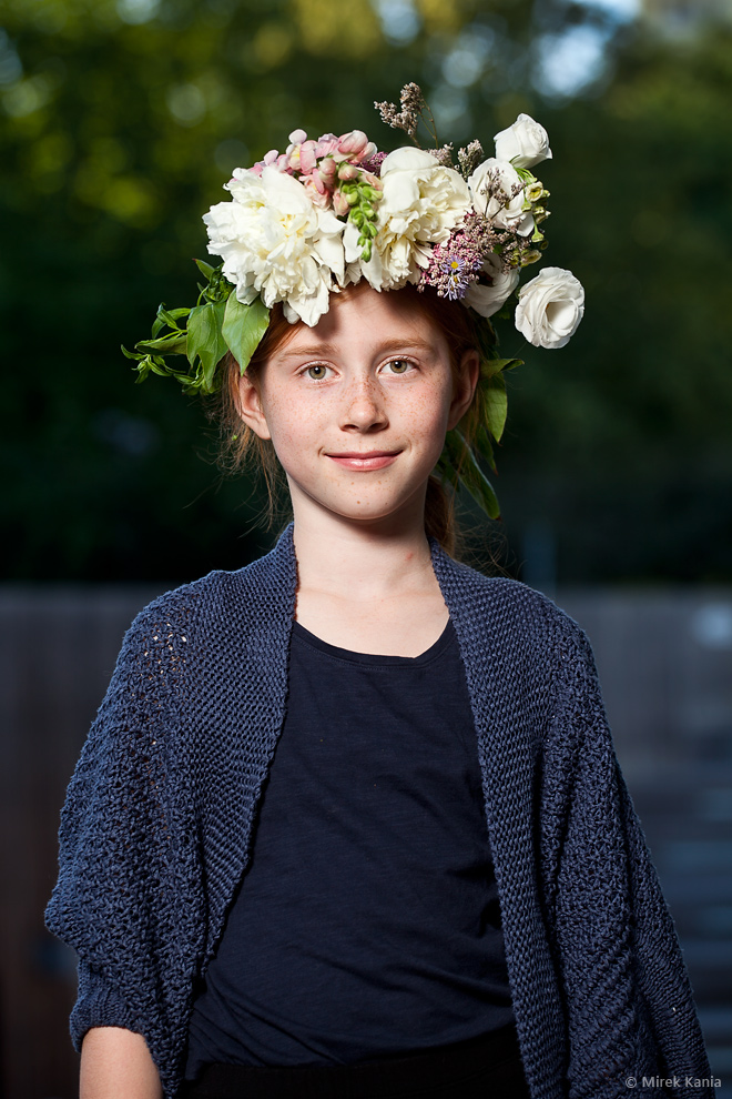 Na zdjęciu widać młodą dziewczynkę w wianku. W tle amfiteatr SDK. 